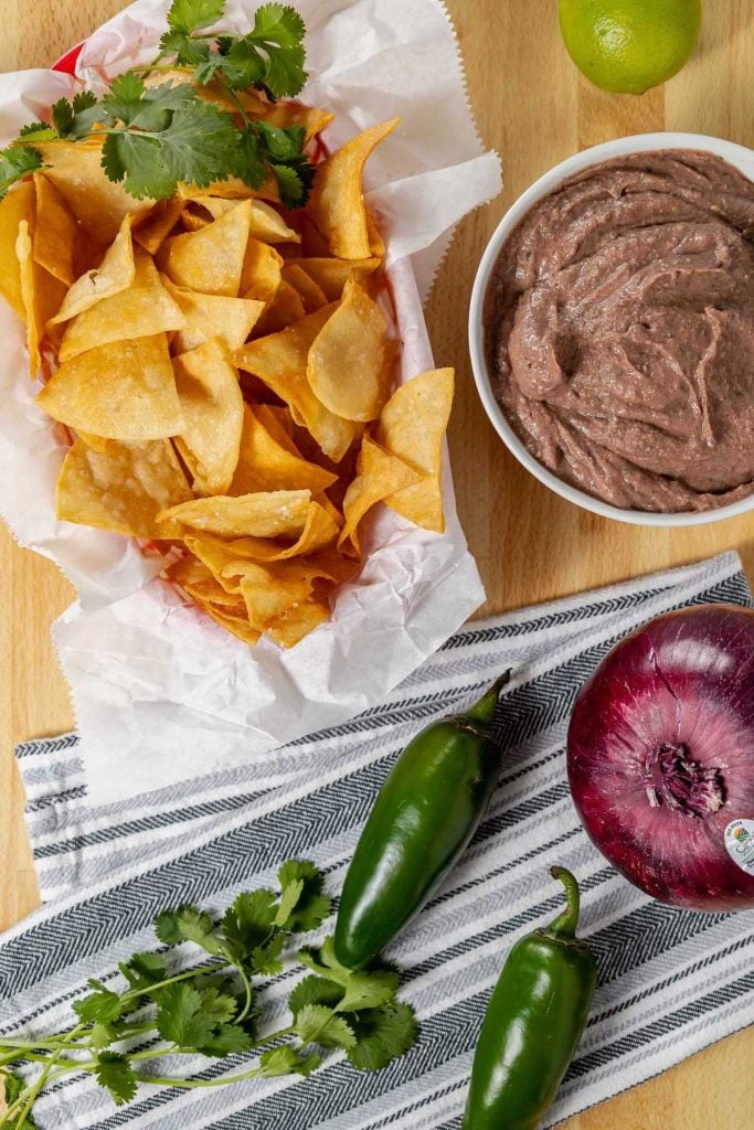 A basket of fresh nachos with this easy vegan bean dip recipe