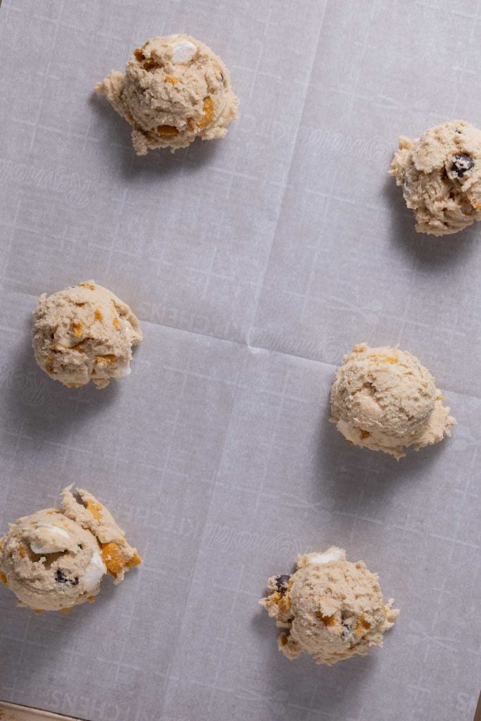 Scooped cookie dough on parchment paper