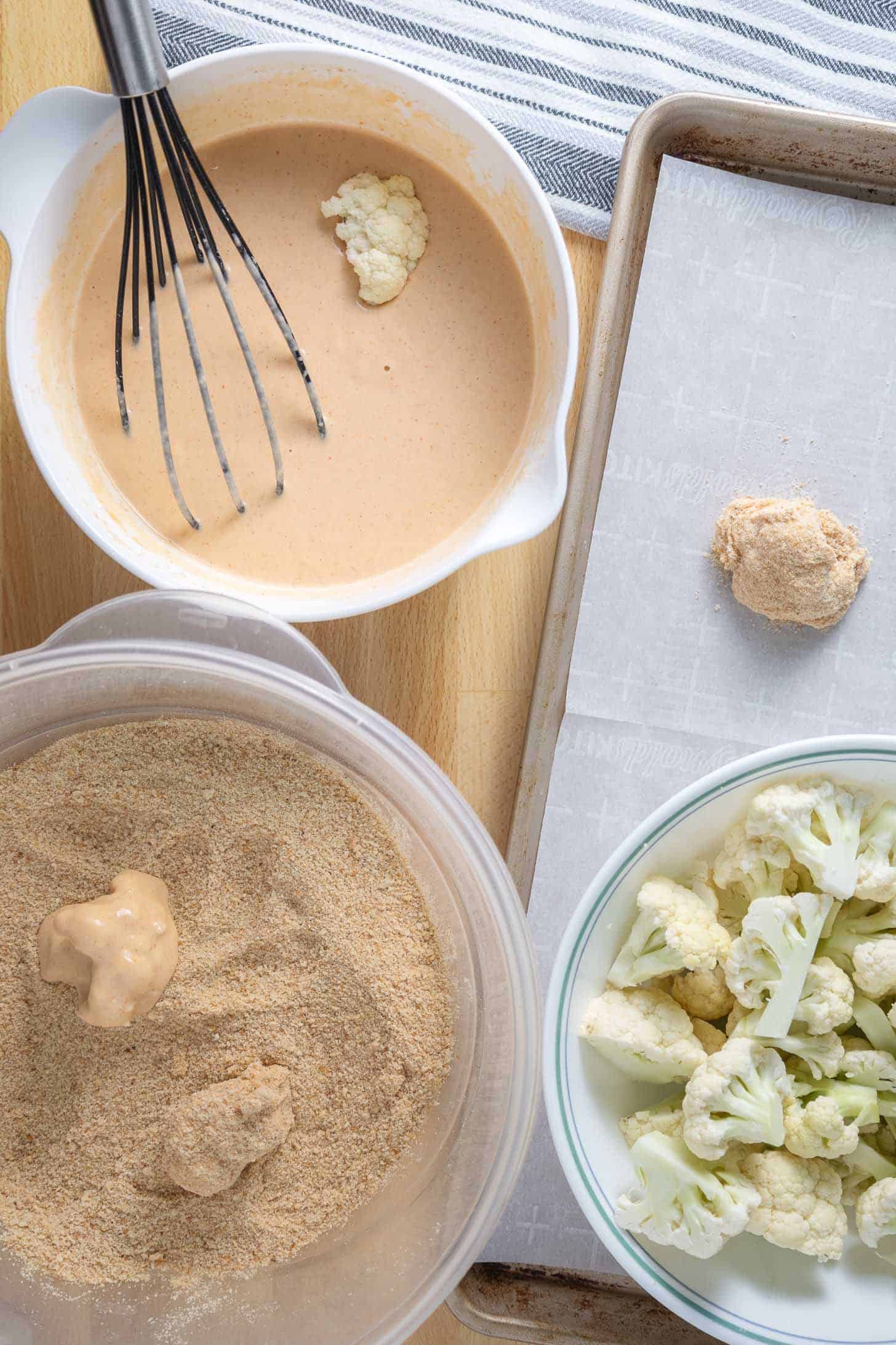 Dipping cauliflower wings in the slurry and coating with breadcrumbs