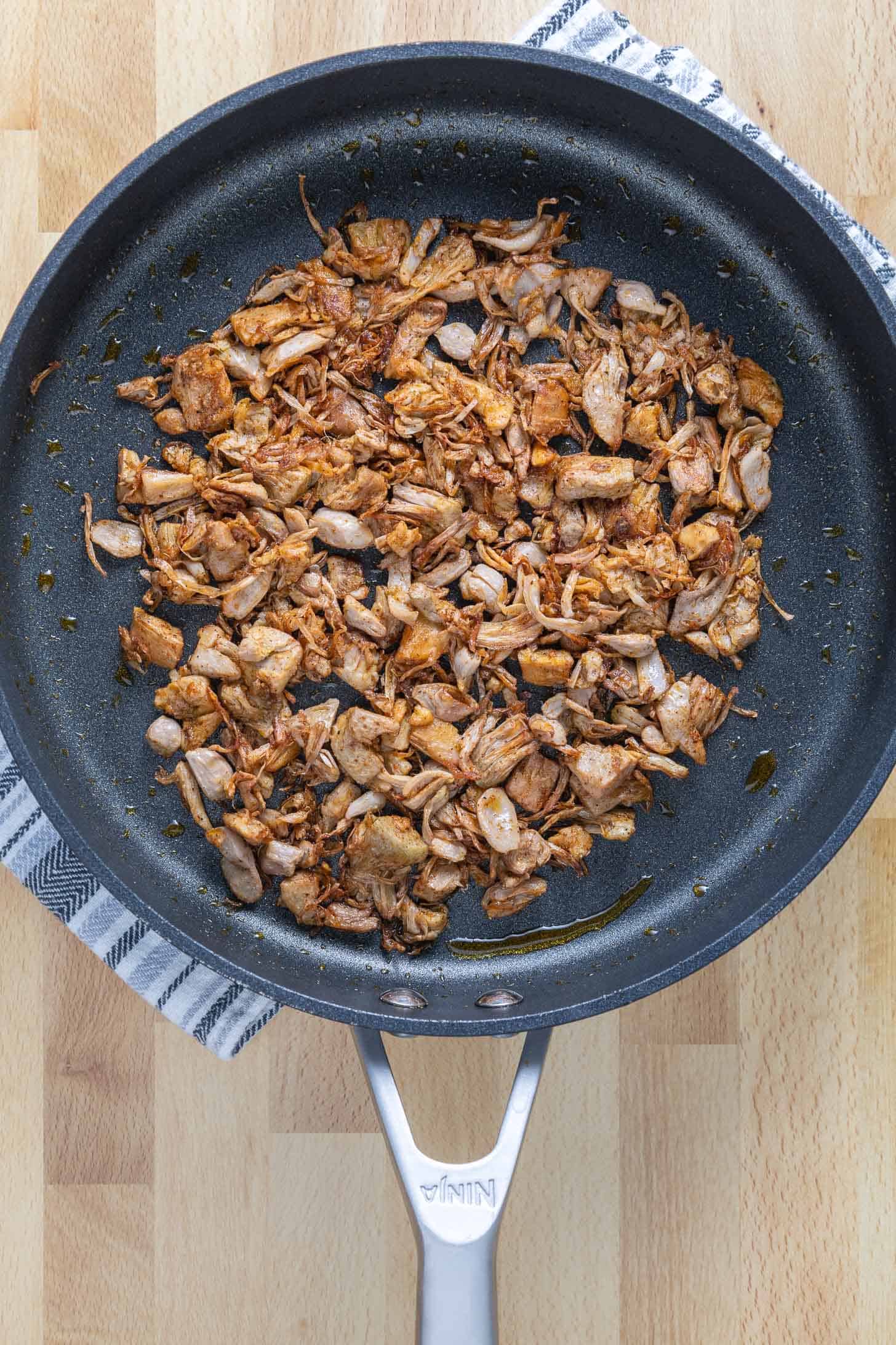 A pan of spicy jackfruit meat for making jackfruit tacos
