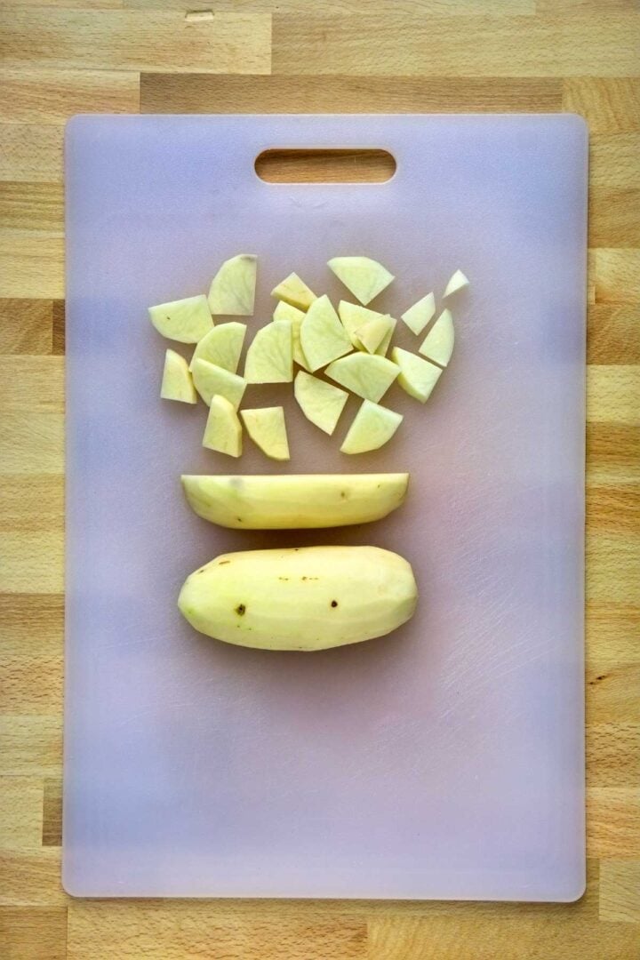 Cut potatoes in quarters and then slices