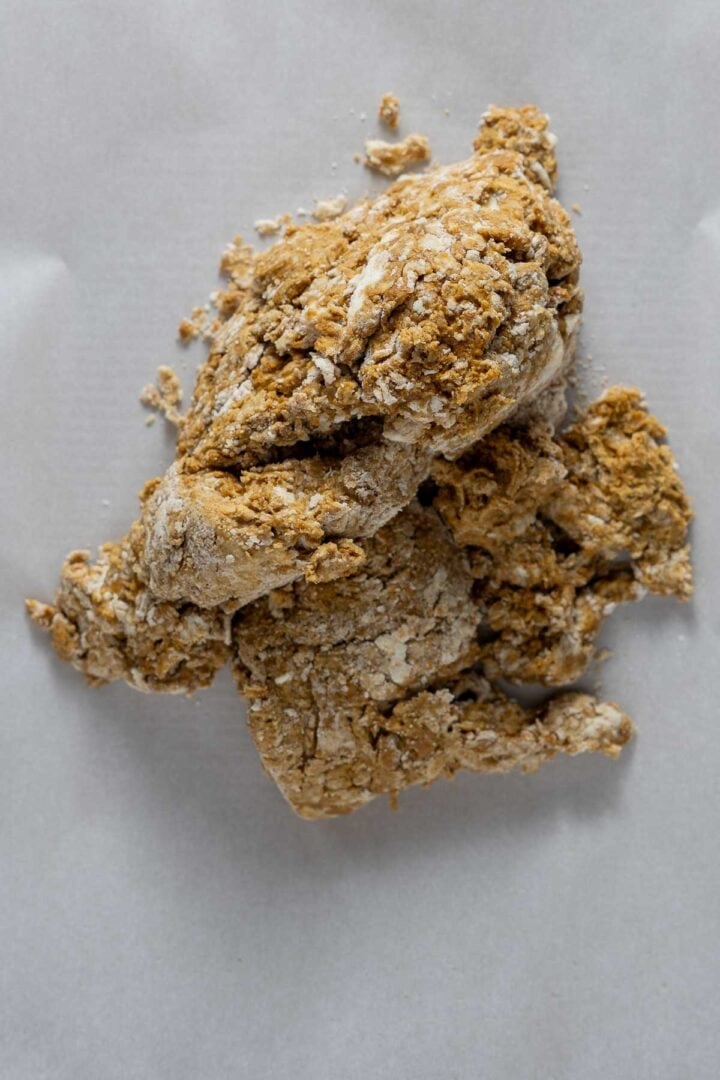 The vegan gingerbread scone dough turned out onto a sheet of parchment paper