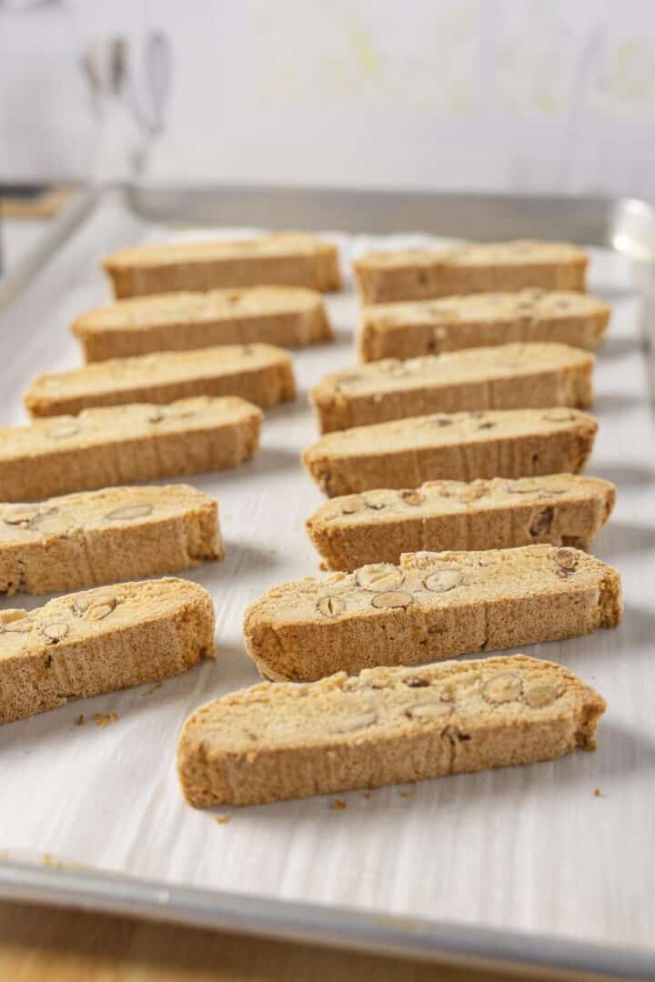Biscotti sliced and arranged on a baking sheet to cook for a bit longer.
