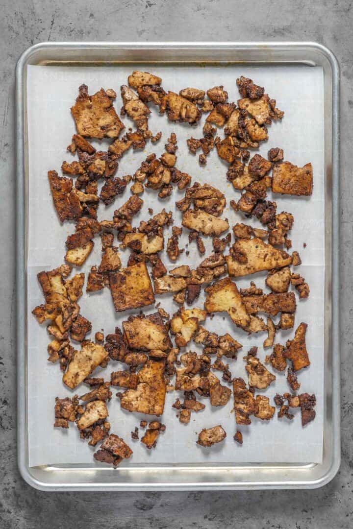 Baking the tofu on a cookie sheet helps dry the tofu into a texture that more resembles meat.