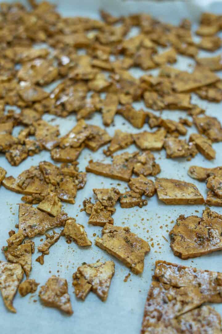 Baking the tofu on a cookie sheet helps dry the tofu into a texture that more resembles meat.